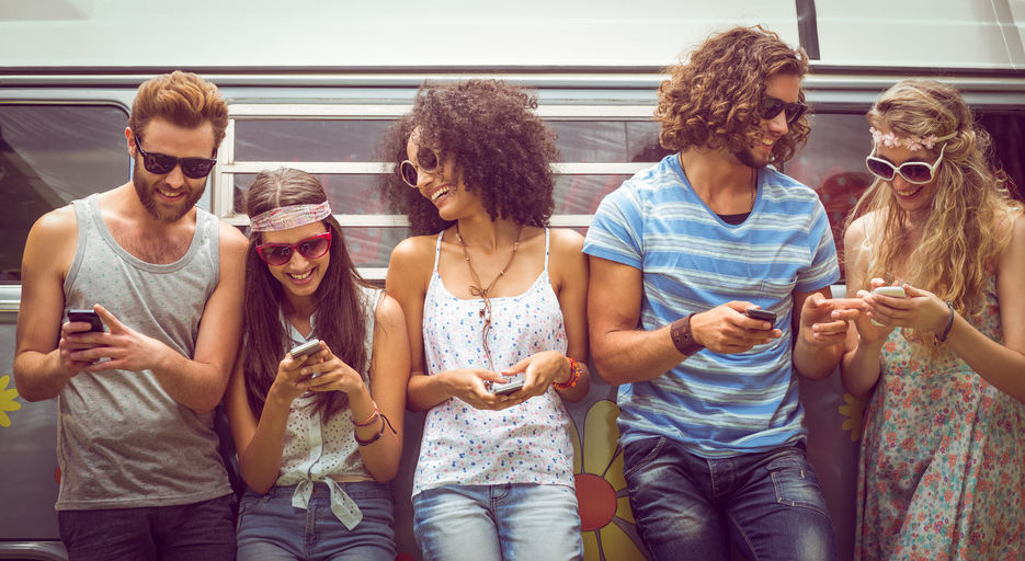 46210037 - hipster friends using their phones on a summers day